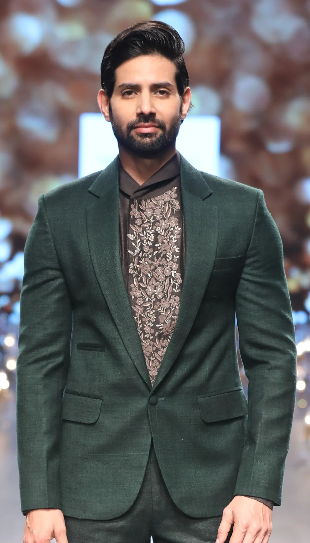 Green matka silk jacket over a black raw silk shirt and trousers