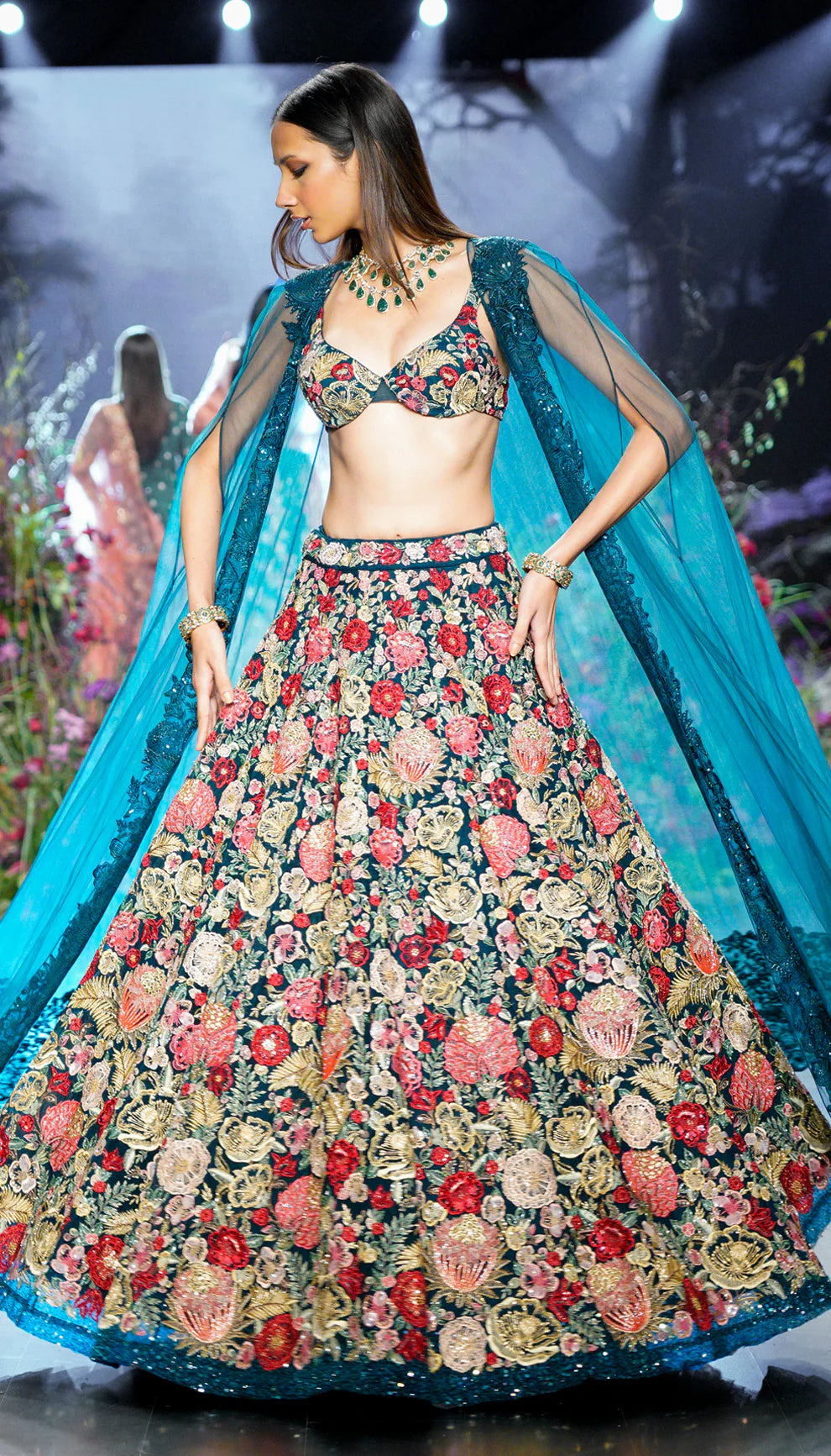 Deep cyan, tulle net lehenga, tropical bloom embroidery, glass beads, sequins, crystals, lehenga, tulle net cape, bustier, wedding, receptions, sangeet nights, festive celebrations, blue lehenga, net lehenga, floral net lehenga