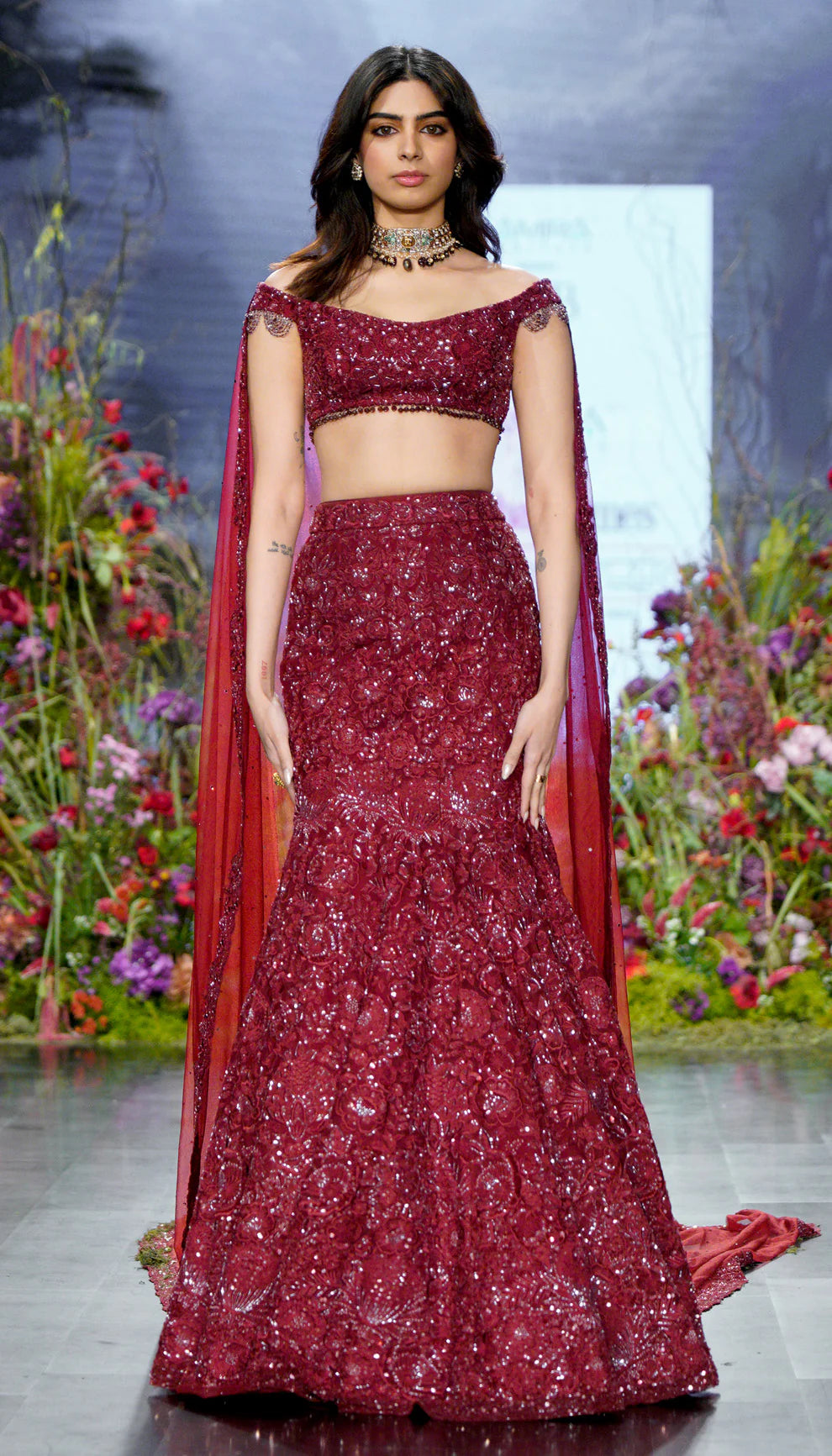 Ruby wine, fluted lehenga, tropical bloom motifs, glass beads, sequins, crystals, veil, off- shoulder blouse, wine lehenga, wedding, receptions, festivities, evening celebrations