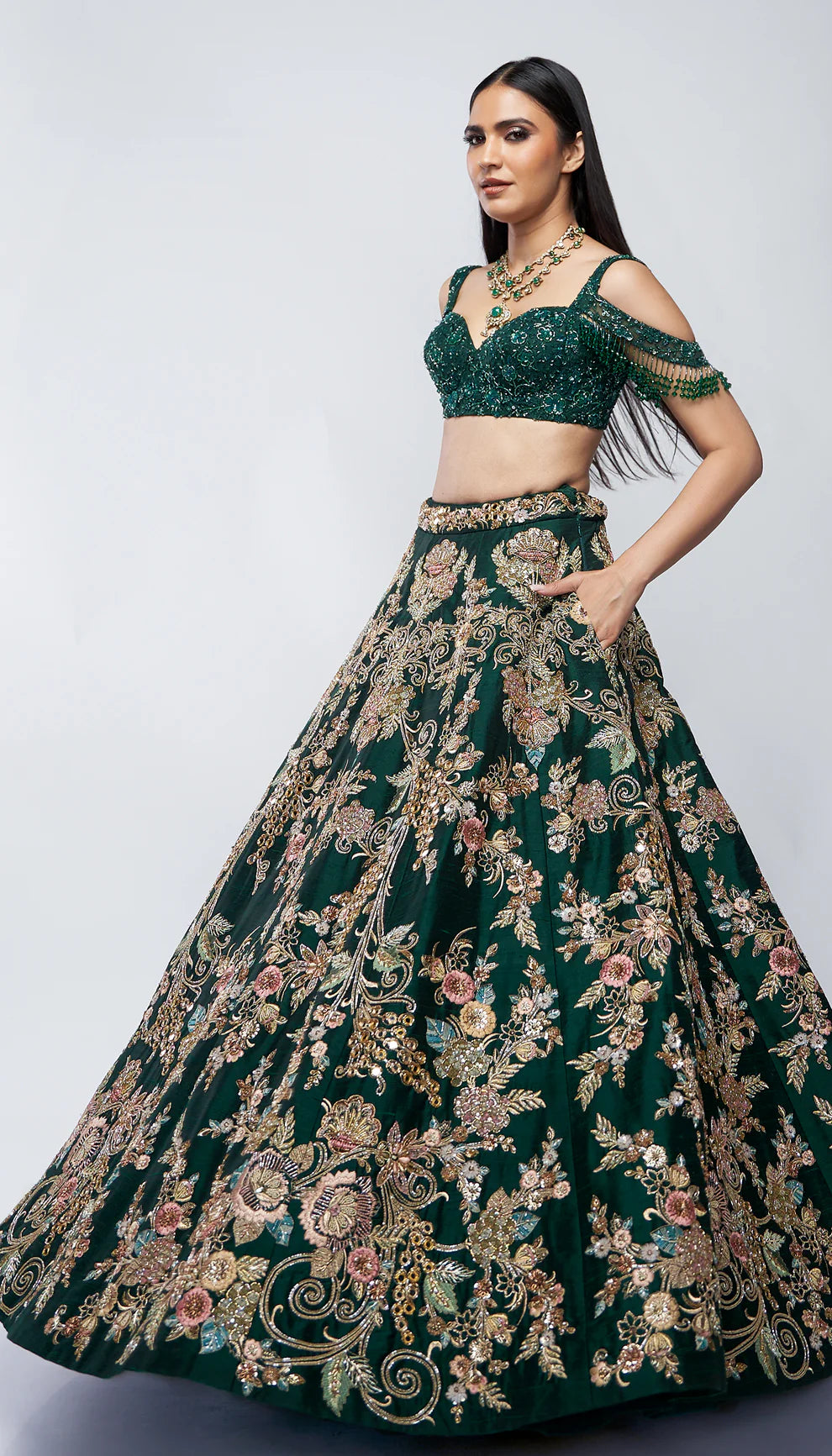 Forest green, raw silk lehenga, florals, gold zardozi, mirrors, glass beadwork, corset- style bodice blouse, silk organza dupatta, lehenga, wedding functions, receptions, evening celebrations, green bridal lehenga, bridal lehenga, sangeet, reception, green lehenga, silk lehenga