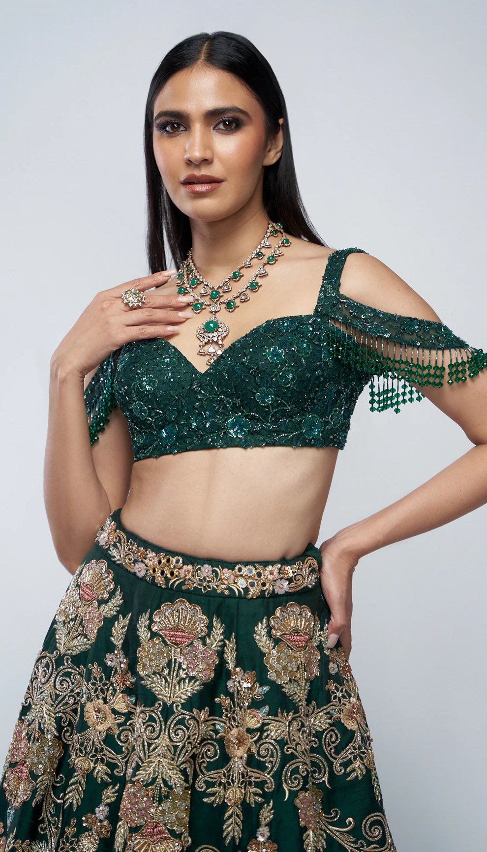 Forest green, raw silk lehenga, florals, gold zardozi, mirrors, glass beadwork, corset- style bodice blouse, silk organza dupatta, lehenga, wedding functions, receptions, evening celebrations, green bridal lehenga, bridal lehenga, sangeet, reception, green lehenga, silk lehenga
