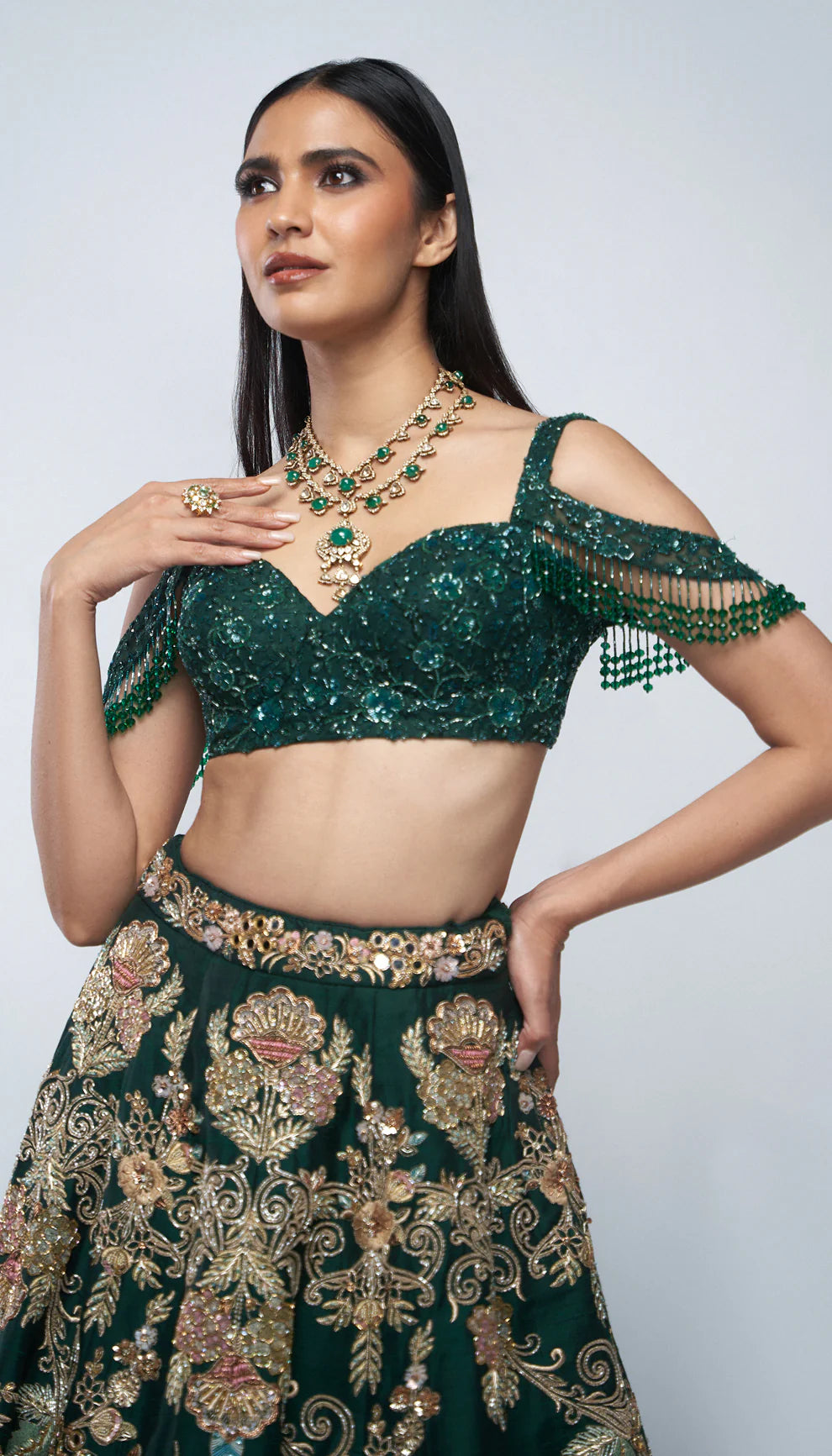 Forest green, raw silk lehenga, florals, gold zardozi, mirrors, glass beadwork, corset- style bodice blouse, silk organza dupatta, lehenga, wedding functions, receptions, evening celebrations, green bridal lehenga, bridal lehenga, sangeet, reception, green lehenga, silk lehenga