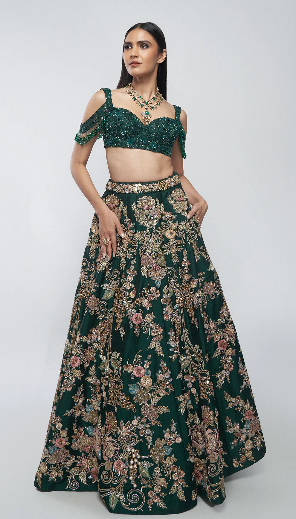 Forest green, raw silk lehenga, florals, gold zardozi, mirrors, glass beadwork, corset- style bodice blouse, silk organza dupatta, lehenga, wedding functions, receptions, evening celebrations, green bridal lehenga, bridal lehenga, sangeet, reception, green lehenga, silk lehenga