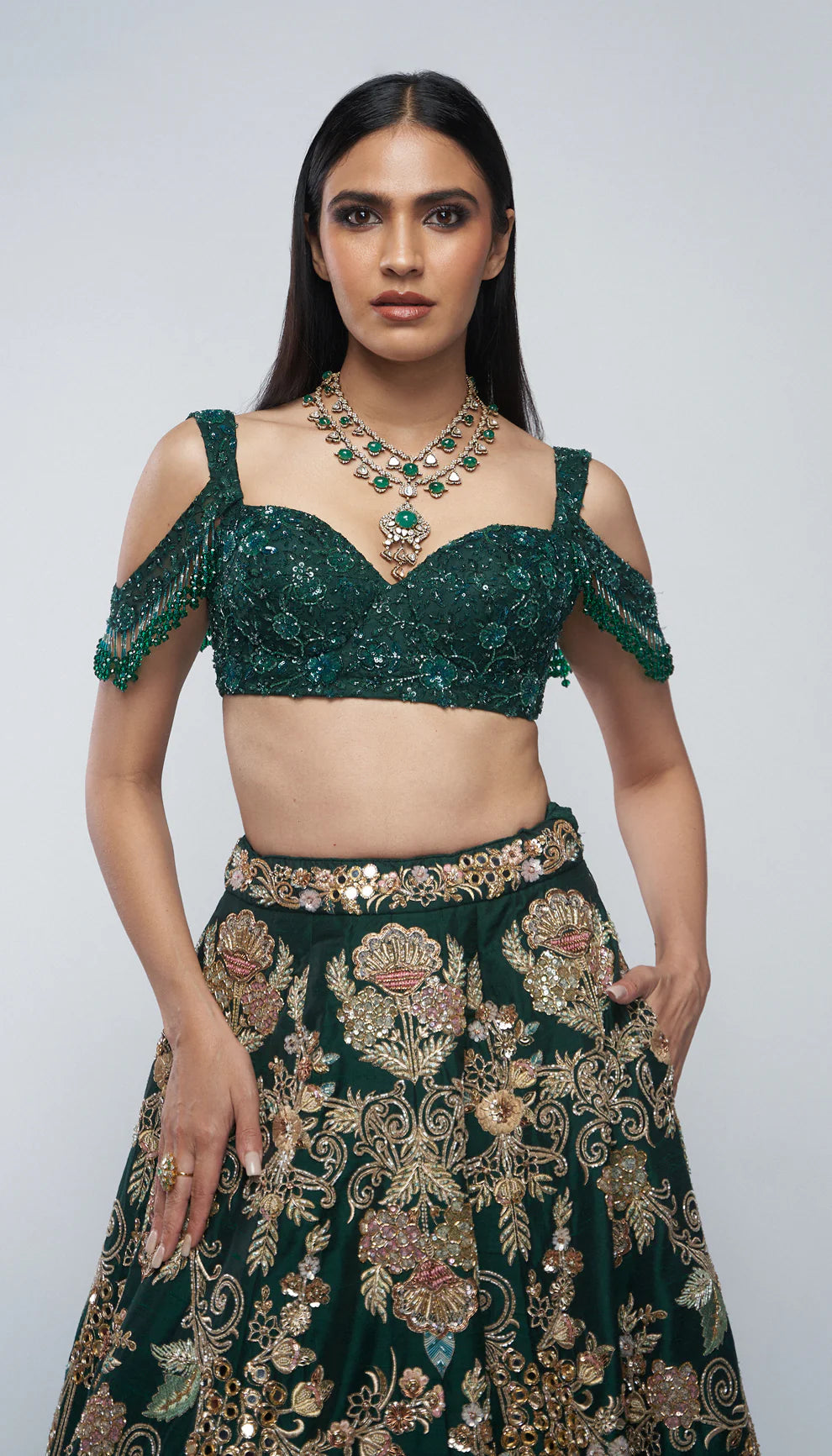 Forest green, raw silk lehenga, florals, gold zardozi, mirrors, glass beadwork, corset- style bodice blouse, silk organza dupatta, lehenga, wedding functions, receptions, evening celebrations, green bridal lehenga, bridal lehenga, sangeet, reception, green lehenga, silk lehenga