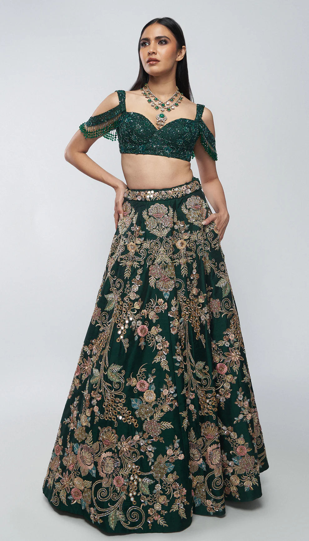 Forest green, raw silk lehenga, florals, gold zardozi, mirrors, glass beadwork, corset- style bodice blouse, silk organza dupatta, lehenga, wedding functions, receptions, evening celebrations, green bridal lehenga, bridal lehenga, sangeet, reception, green lehenga, silk lehenga