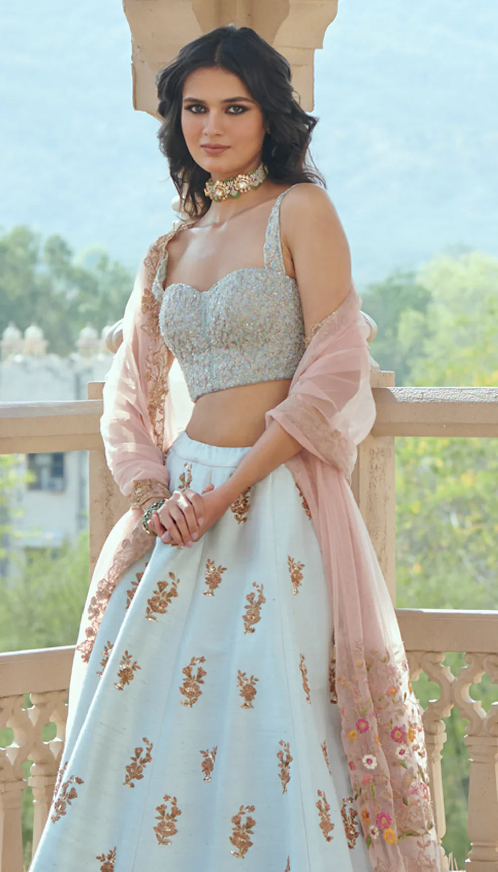 Woman in a light blue embroidered lehenga with a pink dupatta by designers Shyamal and Bhumika.