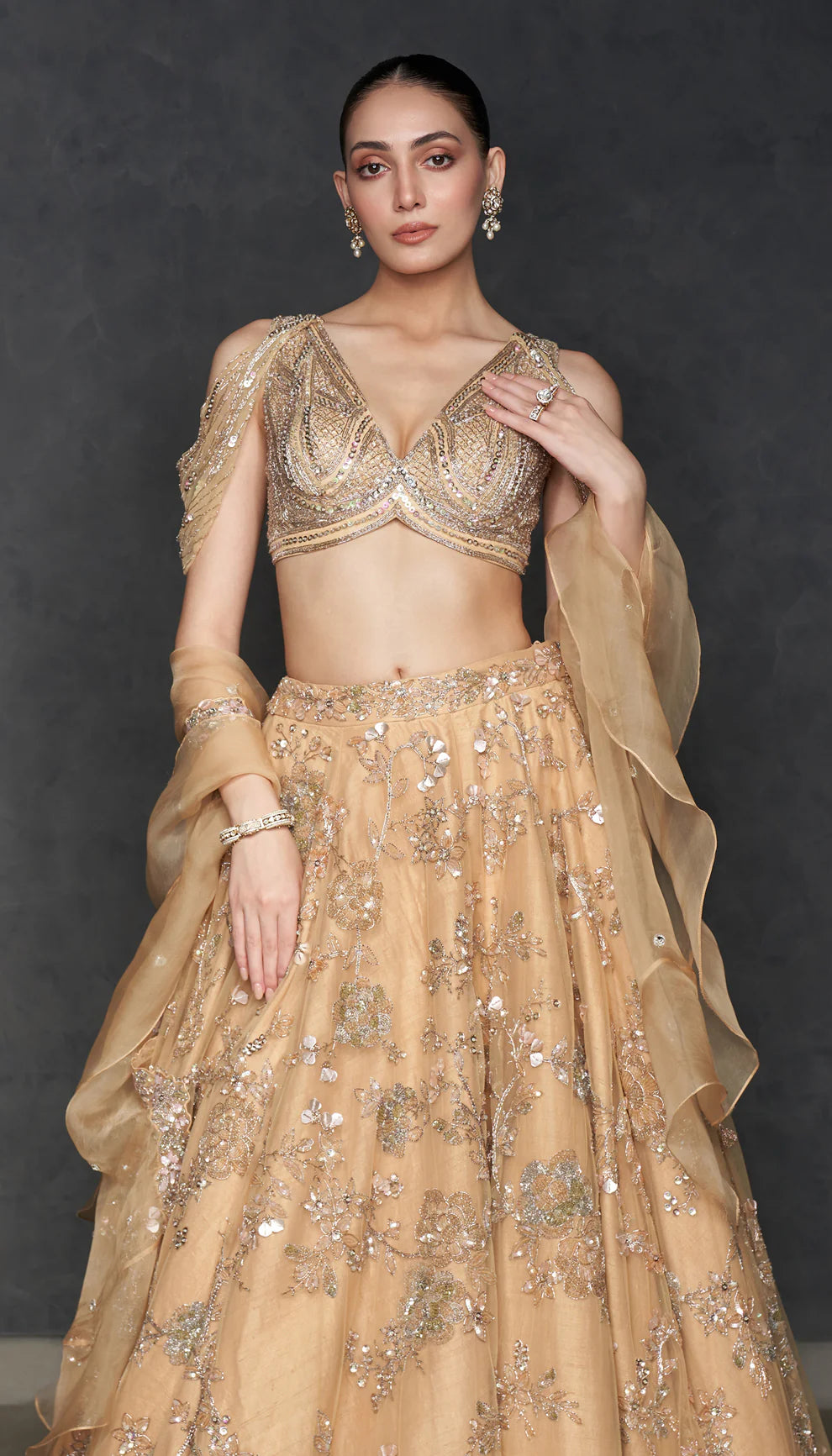 Woman in The Champagne Tulle Lehenga by Shyamal & Bhumika.