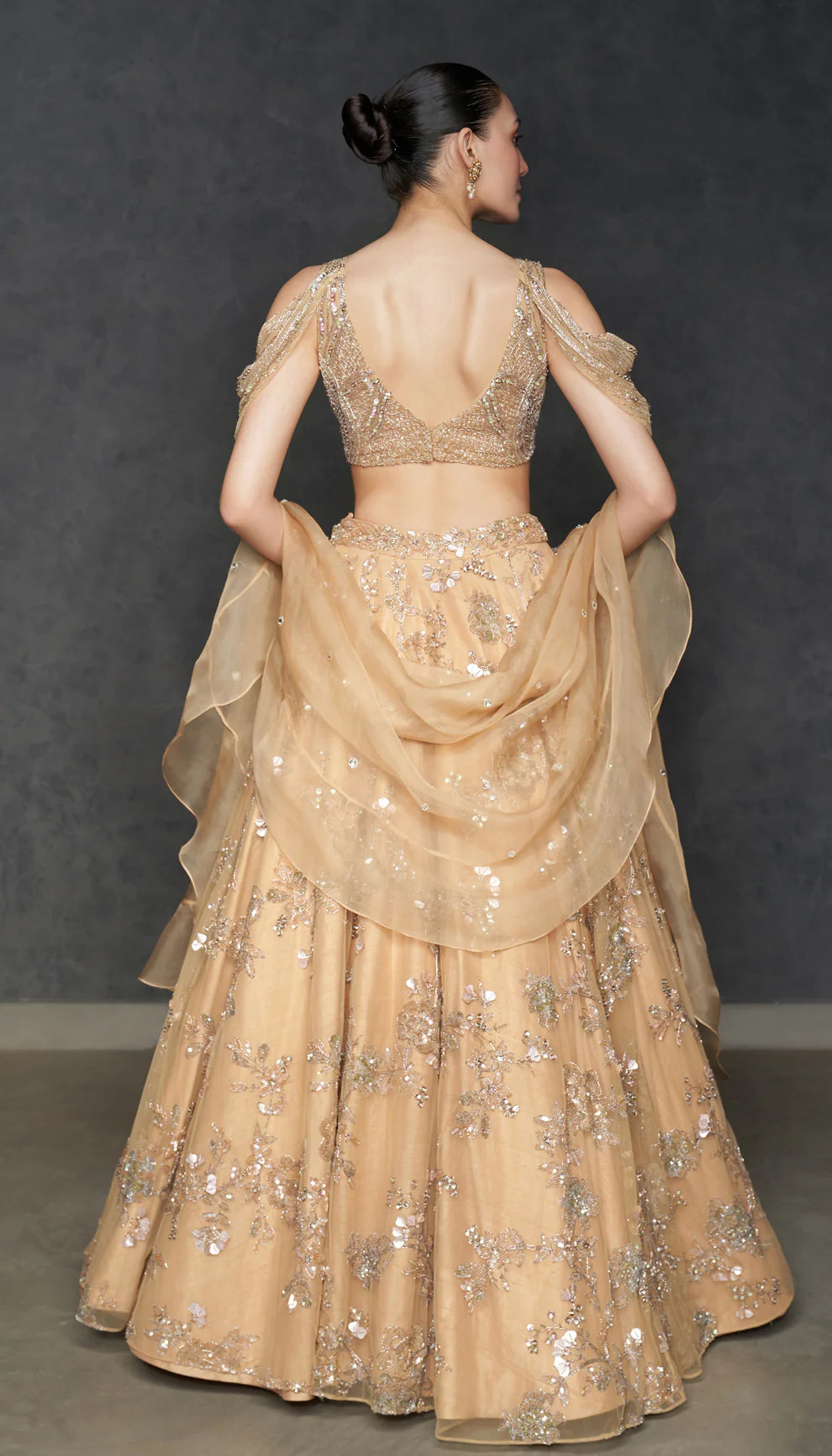 Woman in The Champagne Tulle Lehenga by Shyamal & Bhumika.