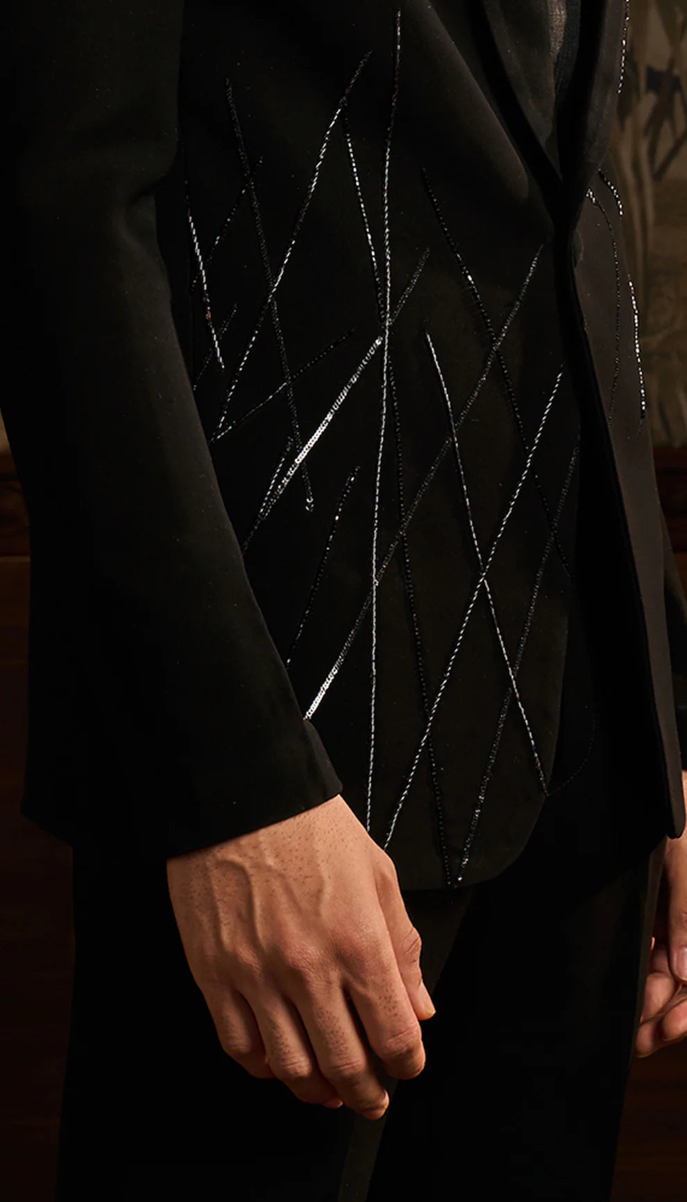 Close-up of a black cocktail jacket suit with geometric pattern on lapel by designers Shyamal and Bhumika