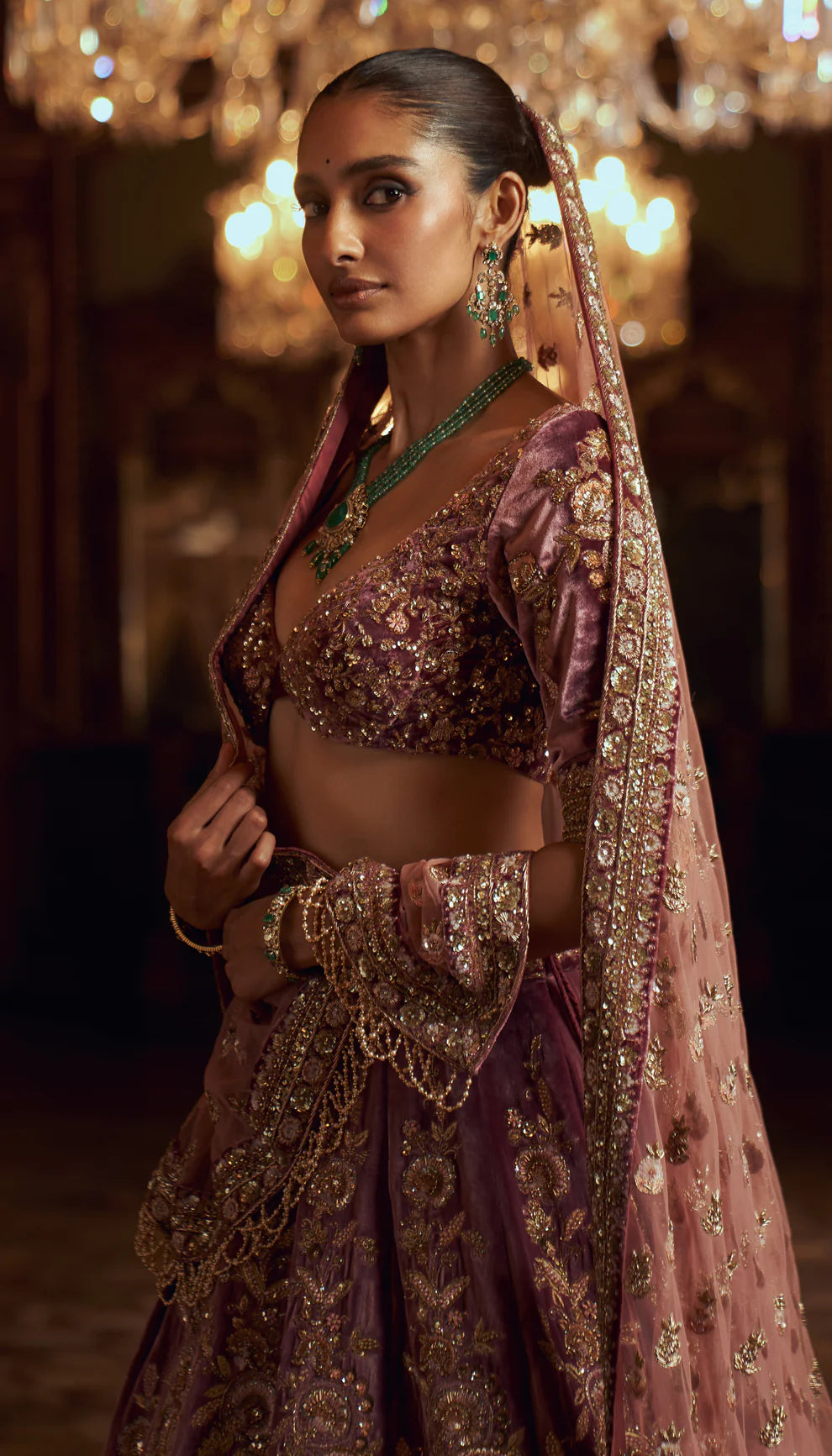 Sepia purple, silk velvet lehenga, gold zardozi embroidery, jaali patterns, Rajasthani miniatures, cut away hem choli, sheer tulle net dupatta, pink bridal lehenga, weddings, festive celebrations, evening occasions, purple lehenga, silk velvet lehenga, designer purple lehenga, designer silk velvet lehenga, destination wedding, sangeet, reception