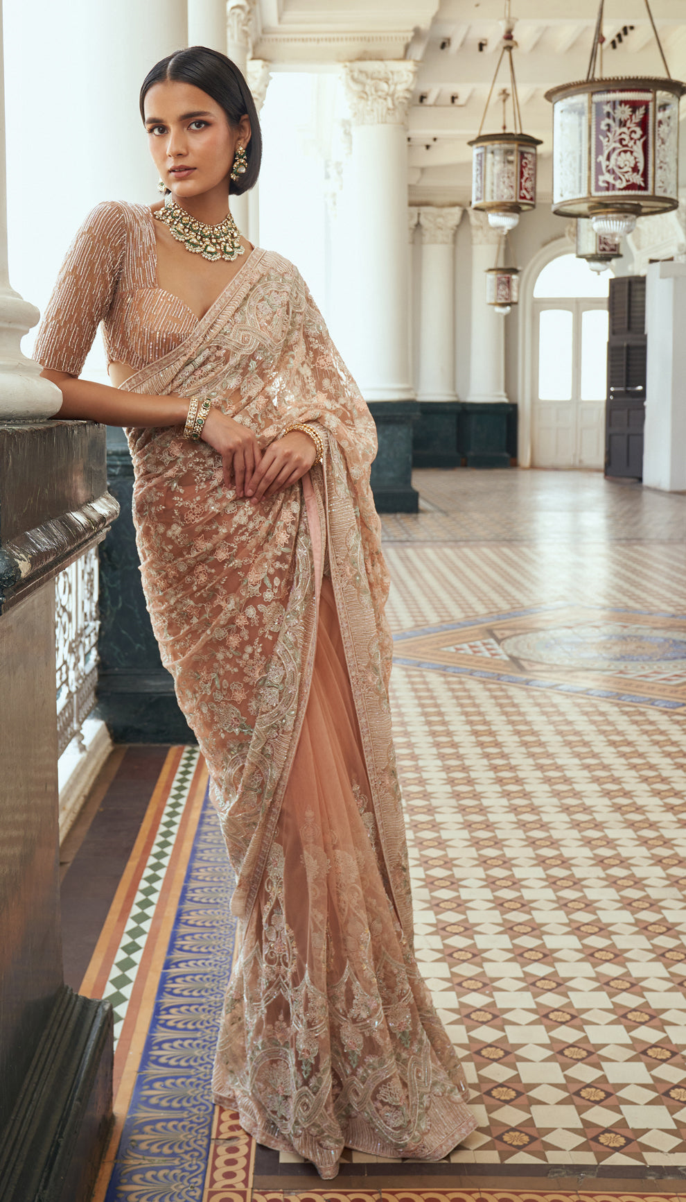 Soft peach blush, tulle net saree, thread embroidery, glass beads, sequin- embellished blouse, peach saree, wedding celebrations, festive gatherings, evening occasions, peach designer saree, designer net saree, destination wedding, sangeet, haldi, mehndi, trousseau, reception, occasion wear, festive wear