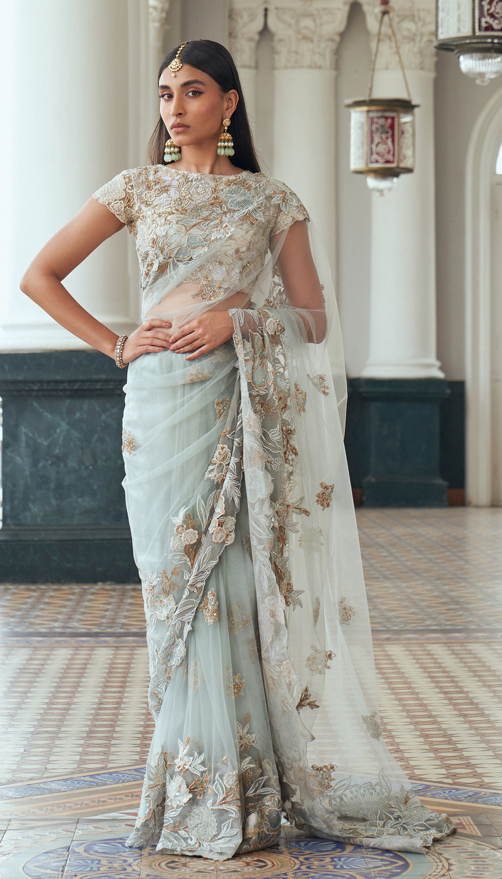 Frost blue, tulle net saree, floral motifs, embroidered, resham, sequins, embellished, warm ivory, tulle net blouse, light blue saree, weddings, festive occasions, evening parties, blue saree, designer blue saree, designer net saree, designer blue net saree, destination wedding, sangeet, haldi, mehndi, reception, festive wear, occasion wear