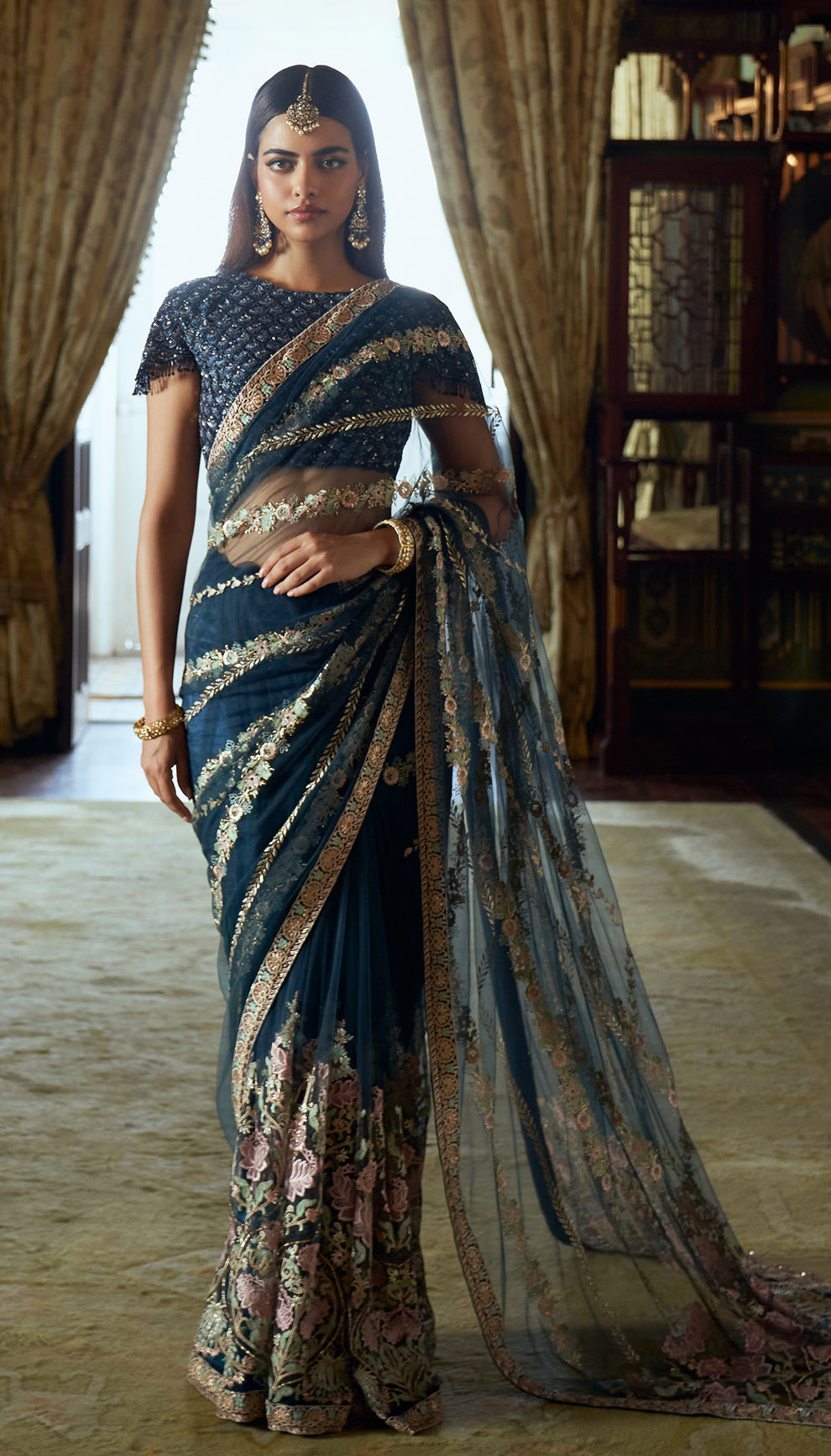 Midnight blue, tulle net saree, lotus motifs, resham, baadla taar, sequined, tulle net blouse, blue saree, evening weddings, festive gatherings, sophisticated celebrations, destination wedding, trousseau, sangeet, haldi, mehndi, reception, dark blue saree, net saree, designer blue saree, designer net saree, festive wear, occasion wear