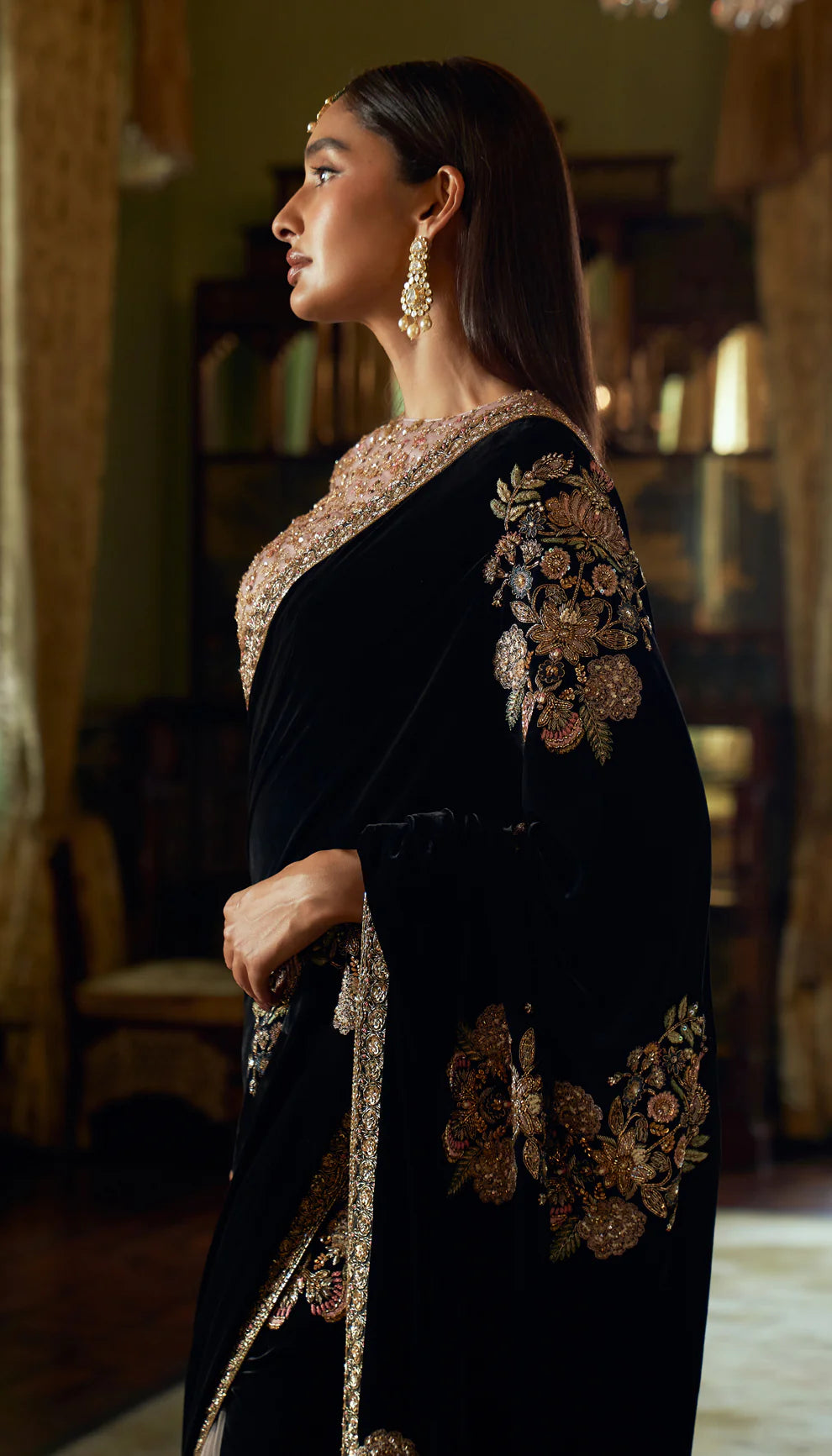 Cobalt black, velvet saree, floral motifs, embroidered, resham, zardozi work, Mughal inlays, embellished, tulle net choli, black velvet saree, bridal functions, festive celebrations, evening events, black saree, designer black saree, designer velvet saree, trousseau