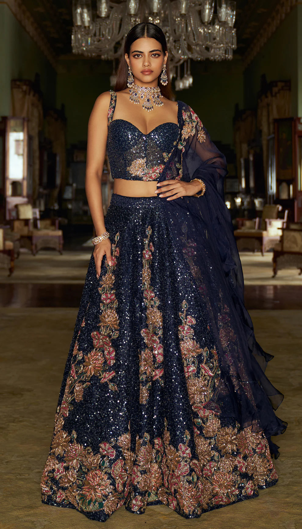 Midnight blue, raw silk lehenga, floral, embroidered, sequin base, glass beads, sequins, gold zardozi, tulle net, corset blouse, sheer organza dupatta, blue lehenga, weddings, festive celebrations, evening receptions