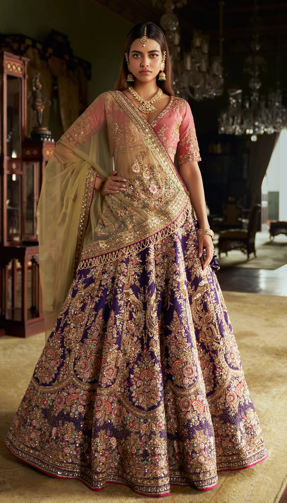 Indigo blue, raw silk lehenga, resham, gold zardozi embroidery, stylized macaw birds, floral motifs, watermelon pink blouse, parrot green tulle net dupatta, purple bridal lehenga, weddings, festive celebrations, evening receptions