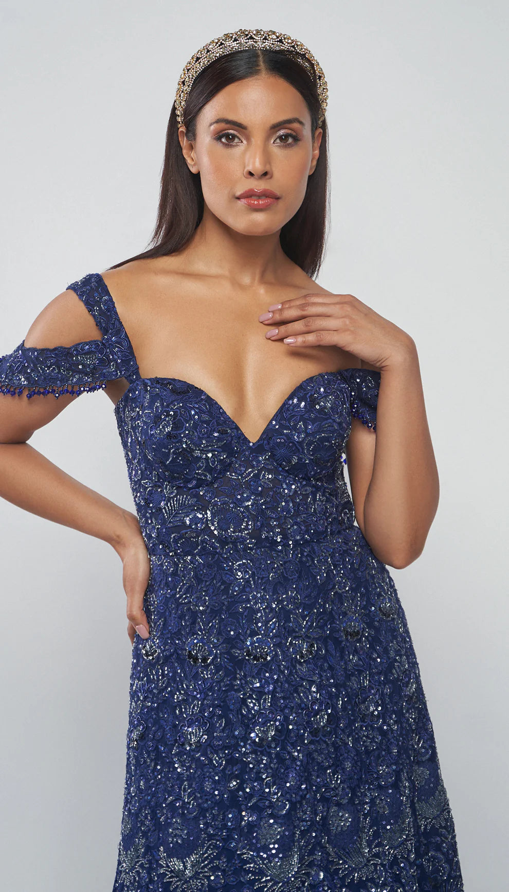 Model wearing a blue evening gown against a white background for designers Shyamal and Bhumika