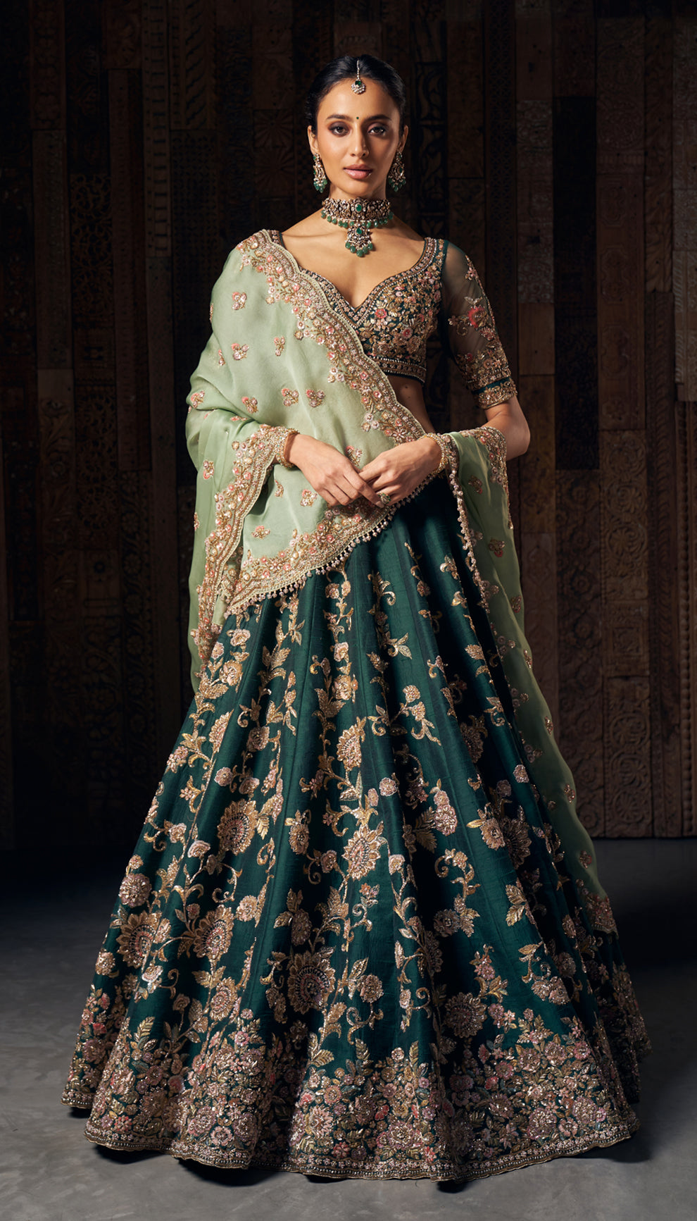 A majestic forest green raw silk lehenga with a matching blouse and mint green dupatta