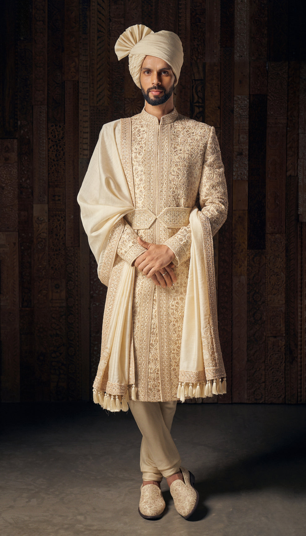 An almond beige raw silk sherwani featuring intricate tone-on-tone embroidery,