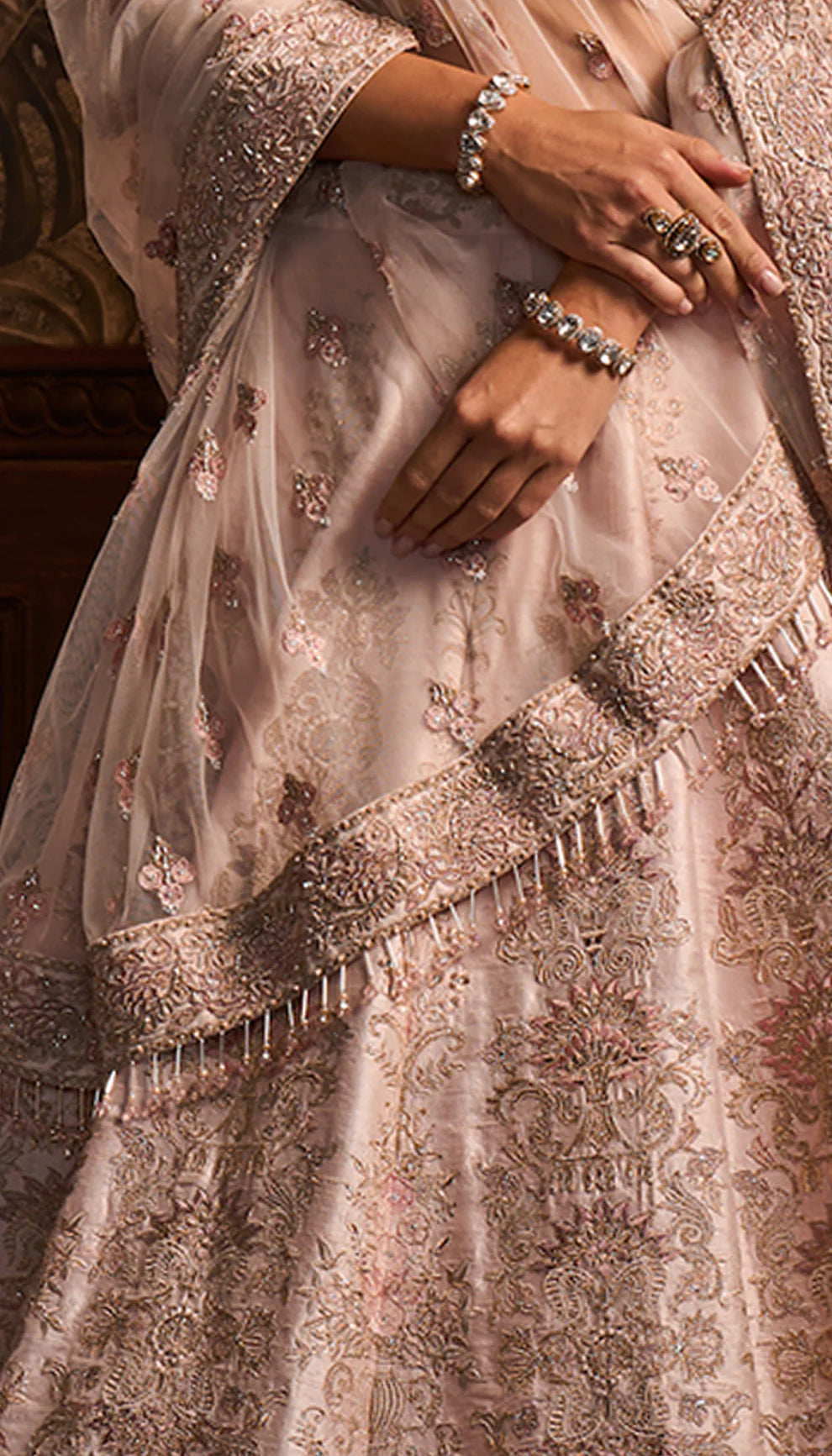 Powder pink raw silk lehenga, resham, rose gold embroidery, complementing satin silk bustier, tulle net dupatta, lehenga, daytime weddings, festive gatherings, evening celebrations