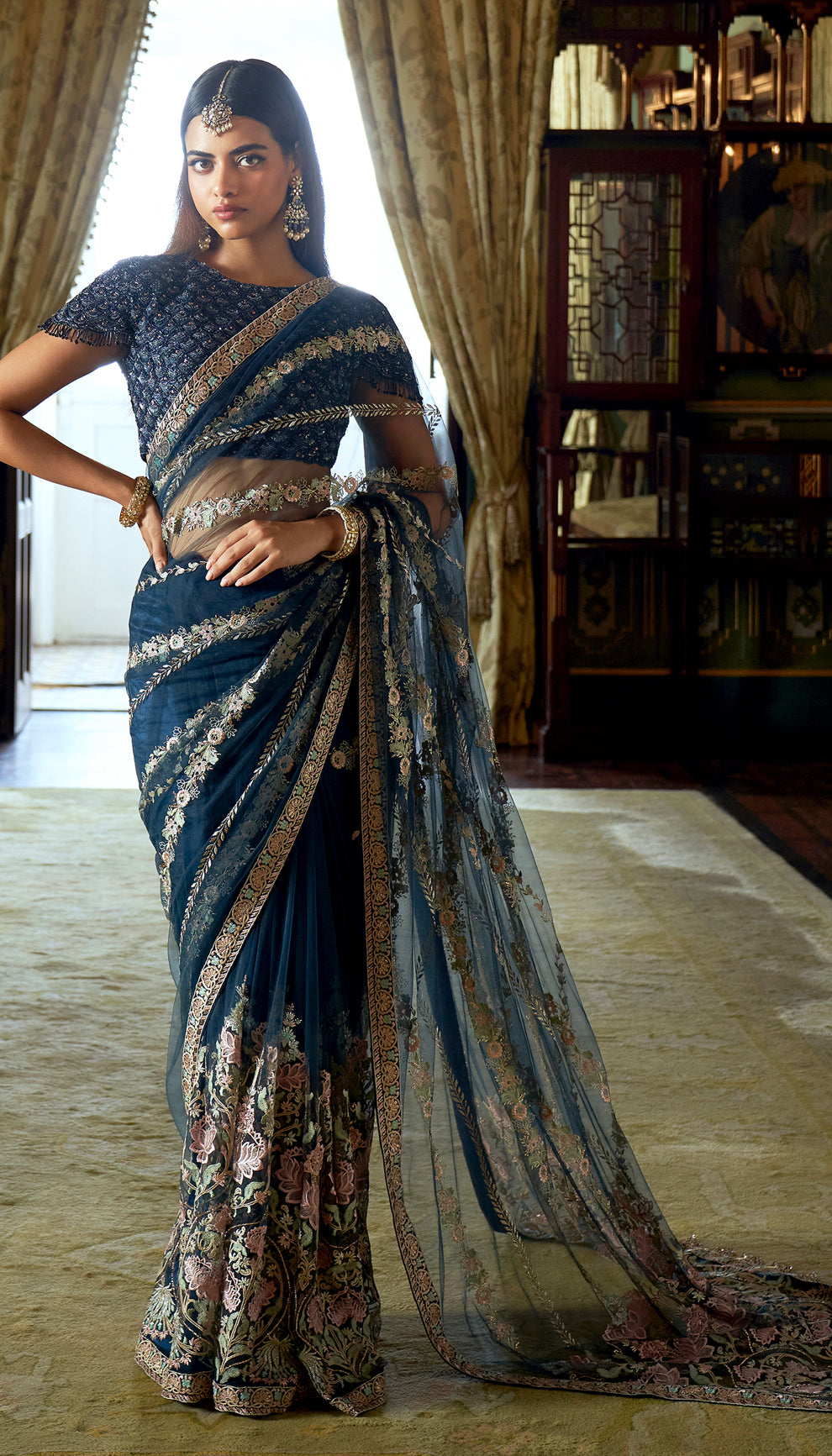 Midnight blue, tulle net saree, lotus motifs, resham, baadla taar, sequined, tulle net blouse, blue saree, evening weddings, festive gatherings, sophisticated celebrations, destination wedding, trousseau, sangeet, haldi, mehndi, reception, dark blue saree, net saree, designer blue saree, designer net saree, festive wear, occasion wear