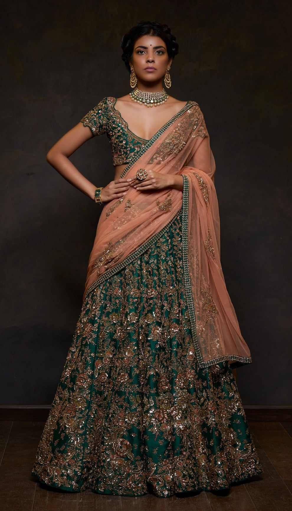 Woman wearing The Classic Emerald Green Raw Silk Lehenga by Shyamal & Bhumika.